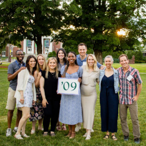 2024_Williston_Reunion-13-class-of-2009-web people standing on grass holding a sign that says '09