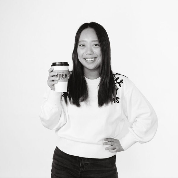 Student holding takeout coffee cup