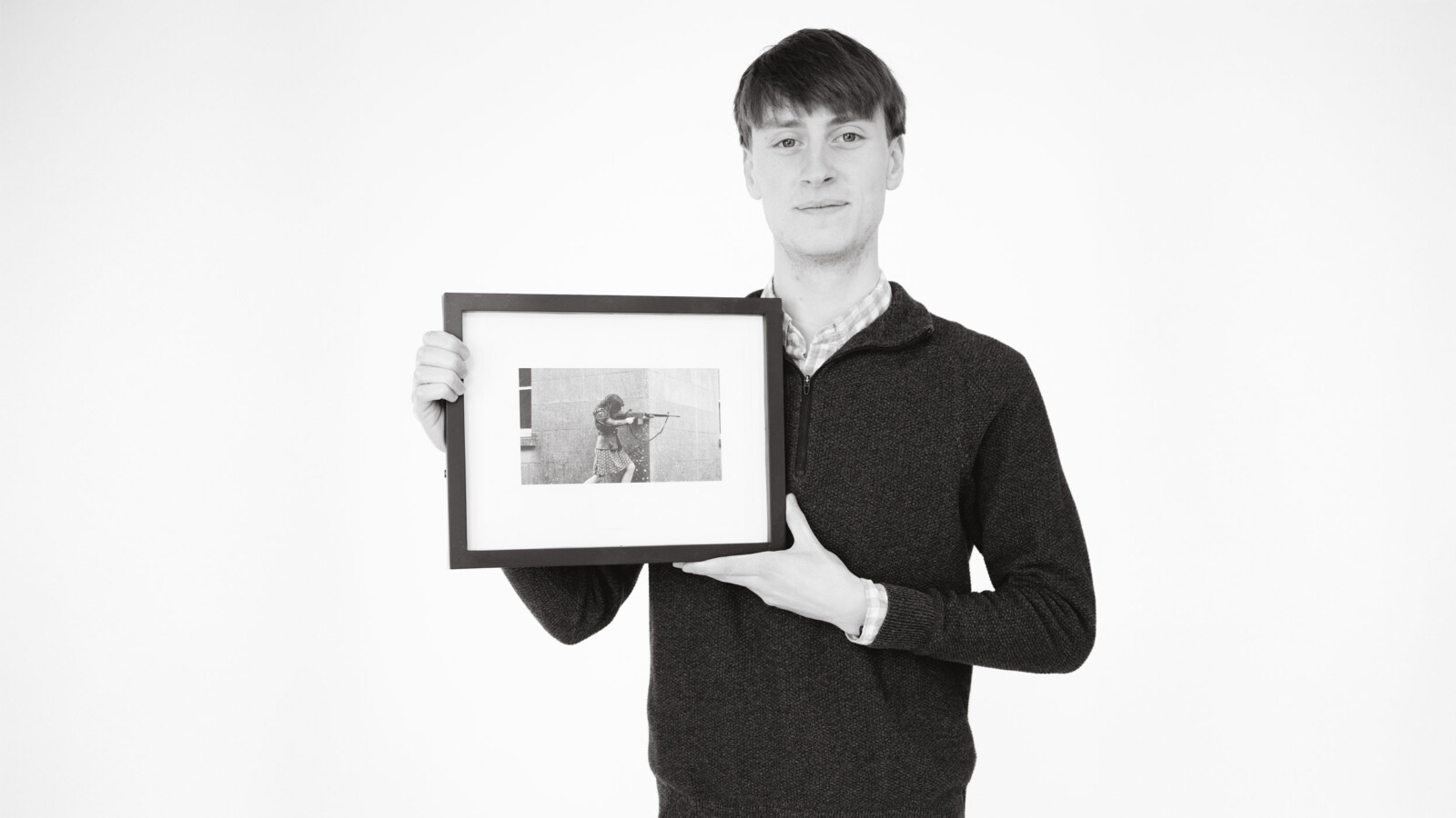 Student holding a framed photograph