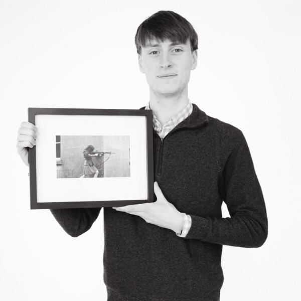 Student holding a framed photograph