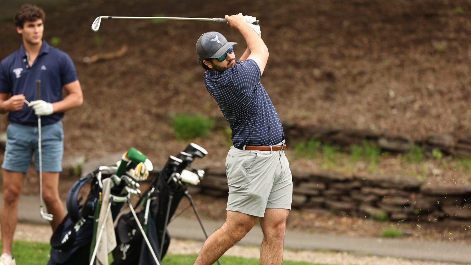 boy swinging golf club