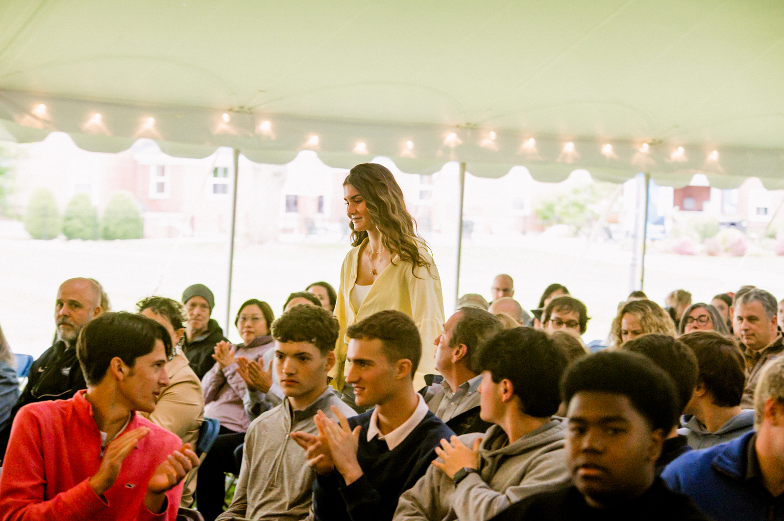 Student walks to accept award during Academic Awards assembly