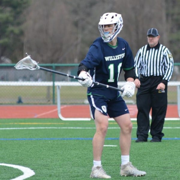 male student on lacrosse pitch