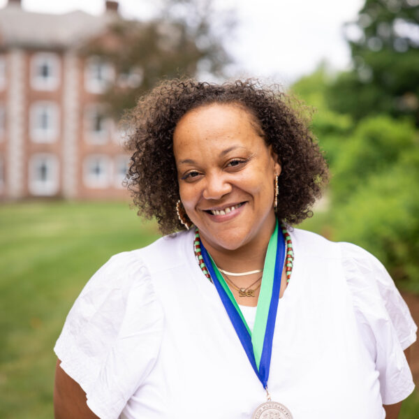 woman posing with medal