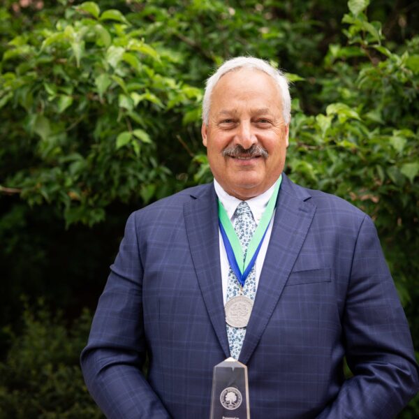 man posing with trophy
