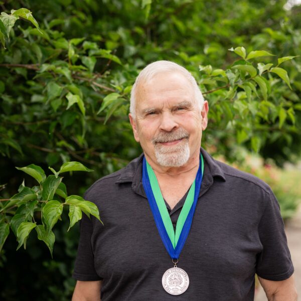 man posing with medal