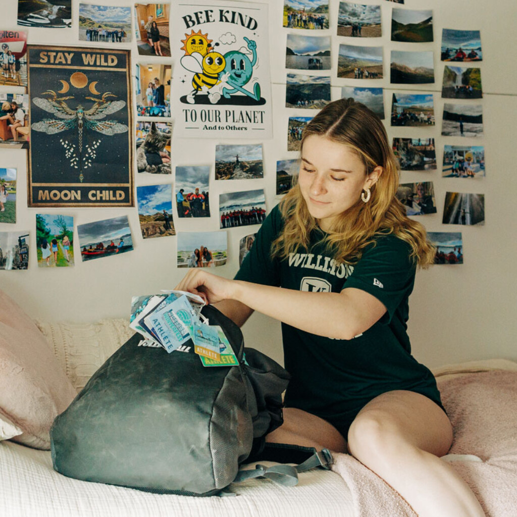 LT-41-3-mel-mccullough-web student on bed with backpack and photos on wall