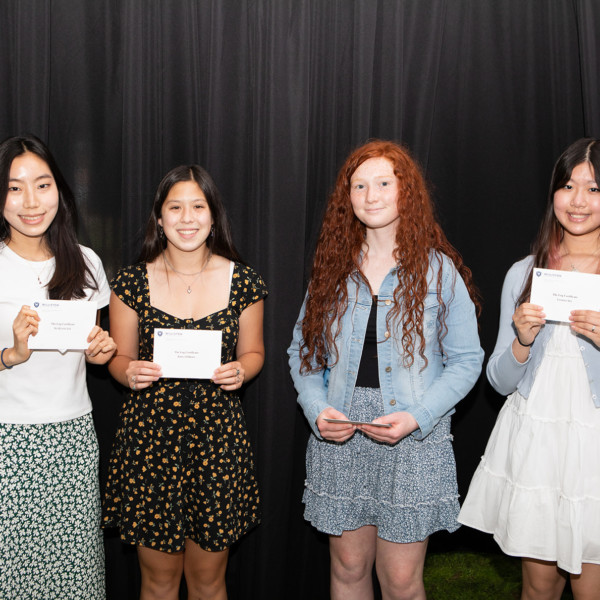 four girls holding awards