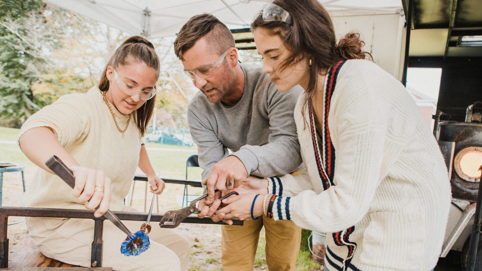 people blowing glass