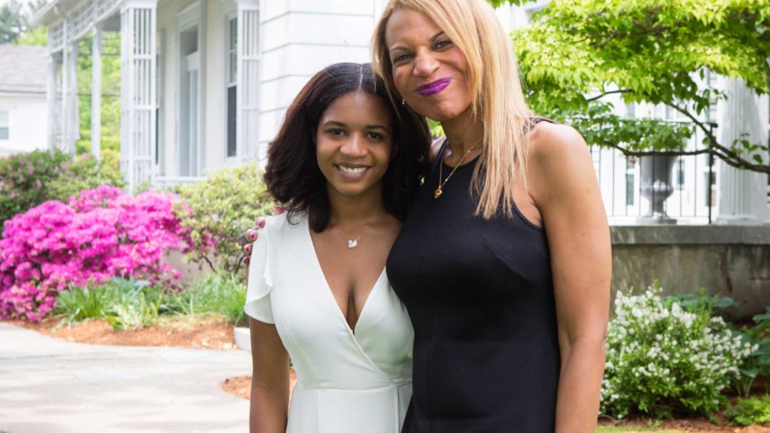mom and daughter standing outdoors