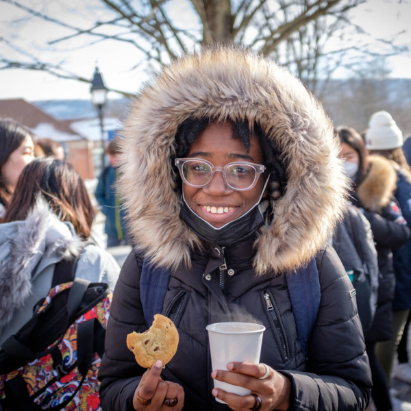 girl in hooded coat with cookie