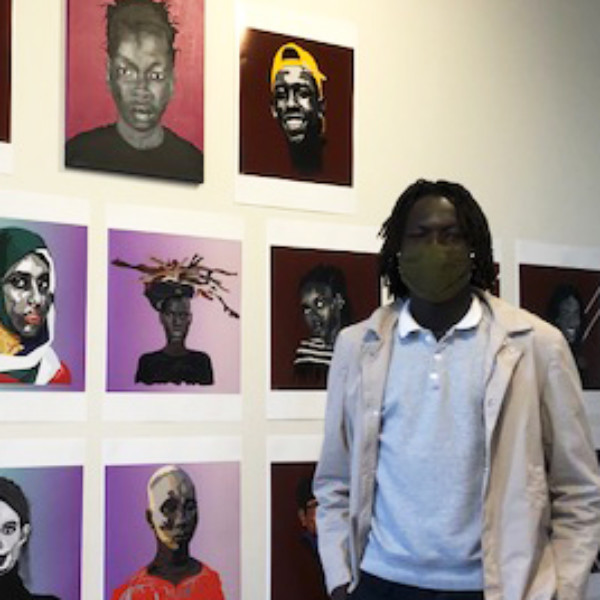young man with images in art gallery